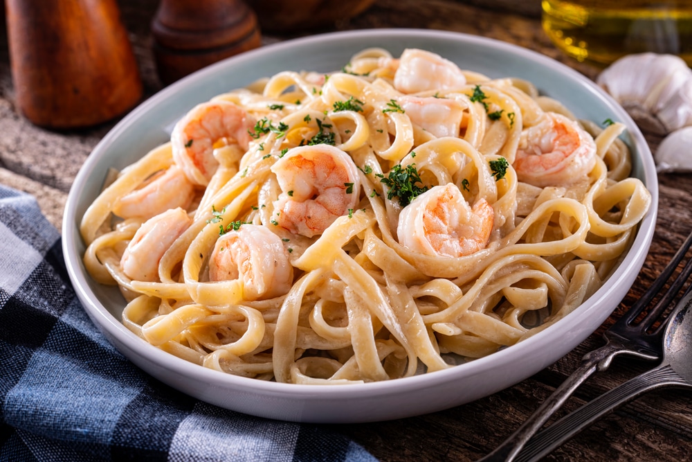 A Plate Of Delicious Shrimp Alfredo With Garlic And Cream