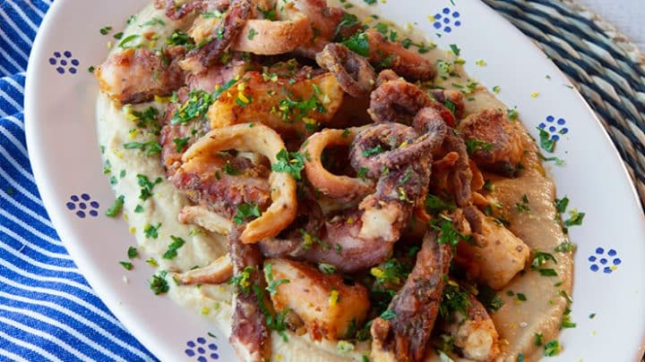 A fried octopus dish with gremolata and cilantro garnish