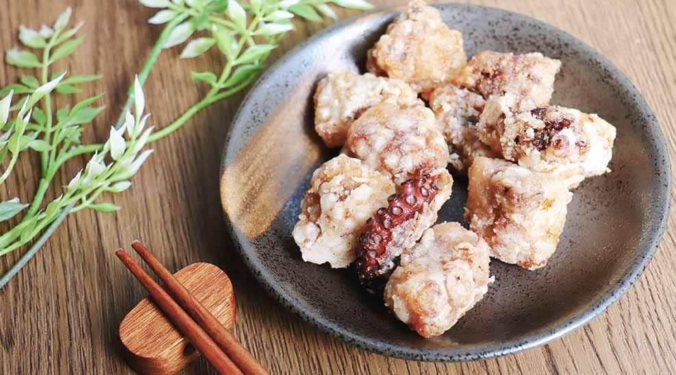 A view of octopus balls plated out with sauce garnish