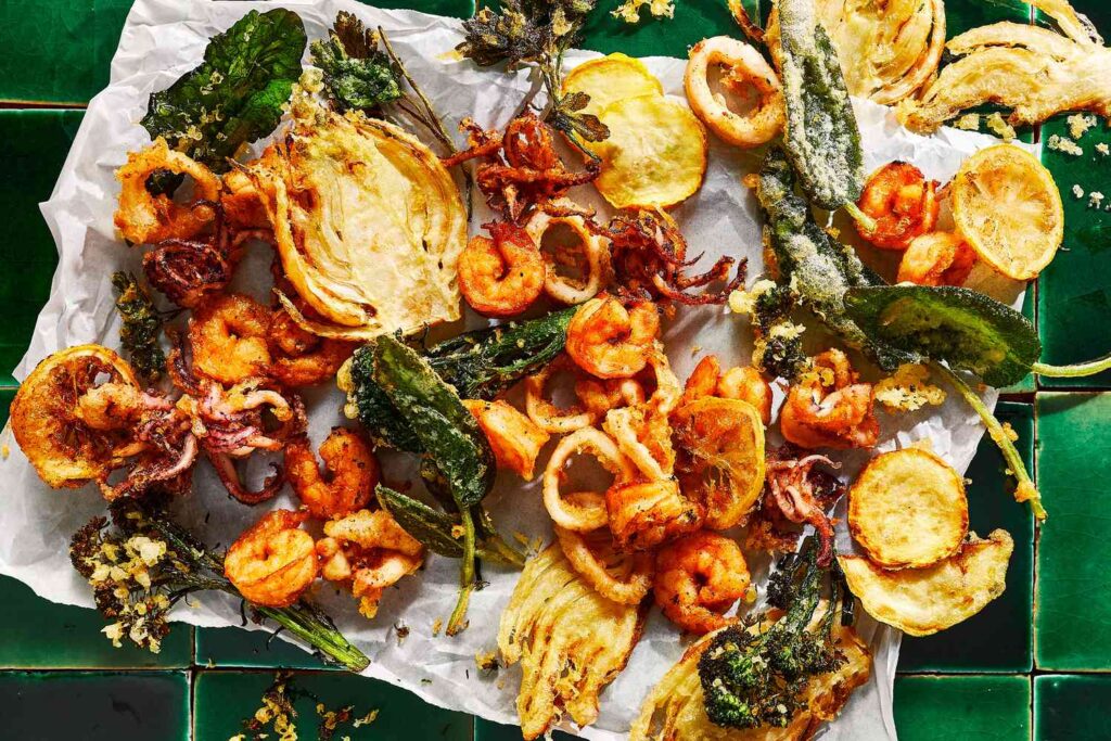 A top view of fried fritto misto platter on a kitchen paper