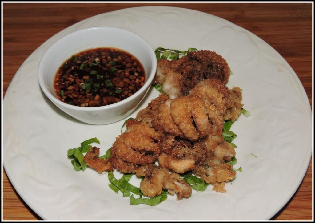 A view of a fried octopus served with chili oil