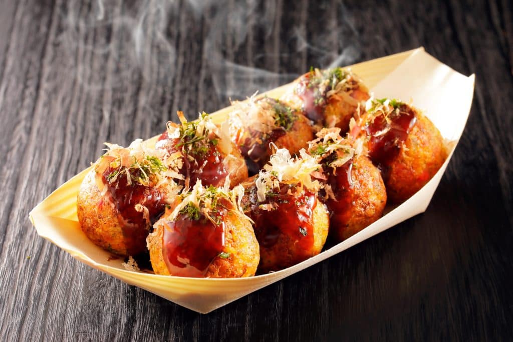 A view of steam coming out of hot Takoyaki balls plated out