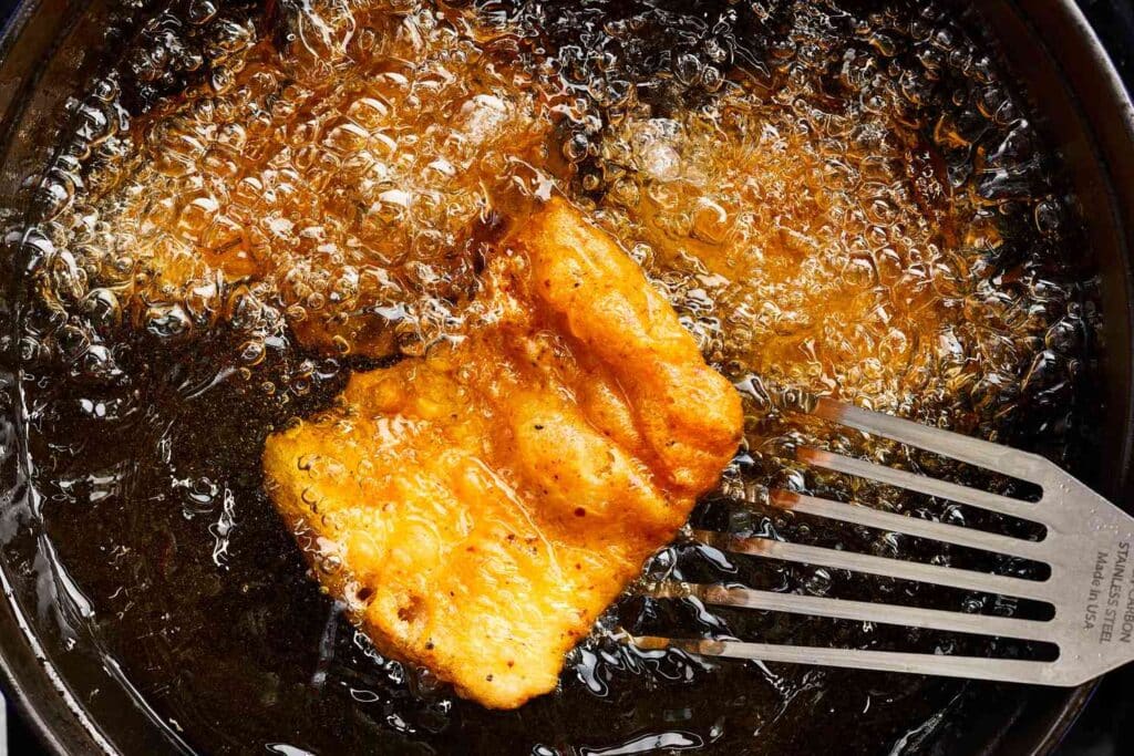 An overhead view of a fish being fried