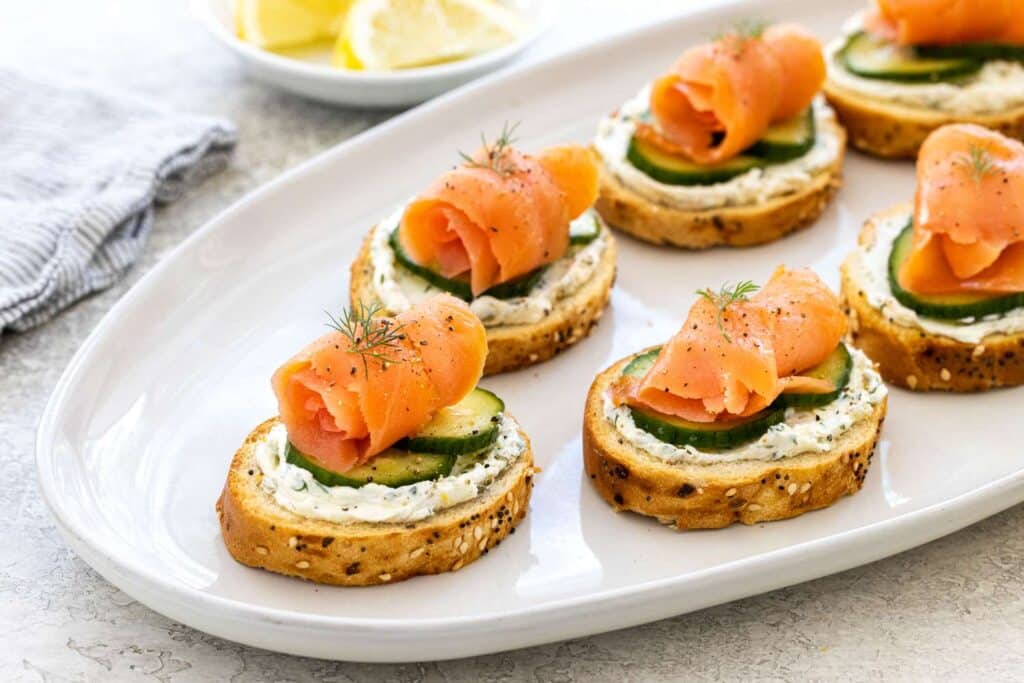 Salmon Crostini with Smoke served in white color dish