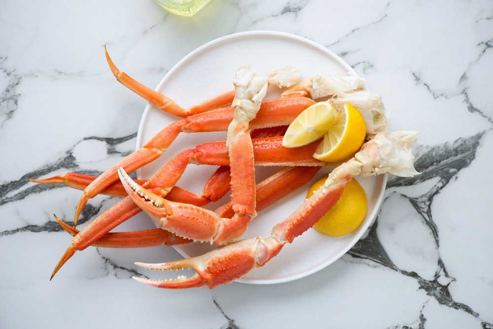 Boiled Crab Legs And Claws With Lemon Wedges On A