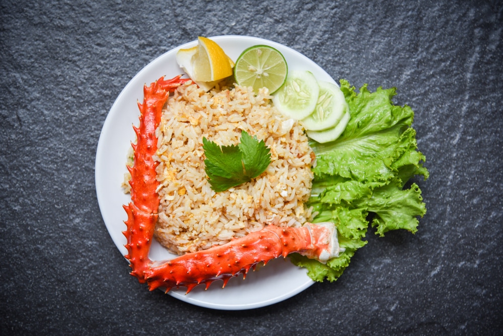 Fried Rice crab seafood / Healthy food fried rice with crab legs with egg lemon and cucumber on white plate