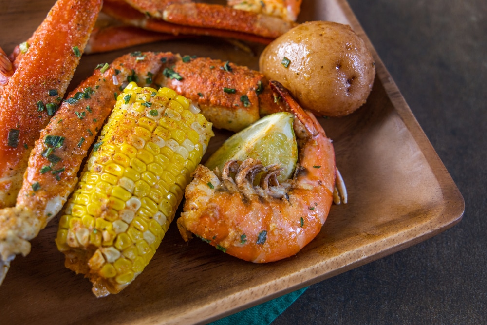 Wood Platter Of Southern Garlic Crabs Seafood Boil With Alaskan