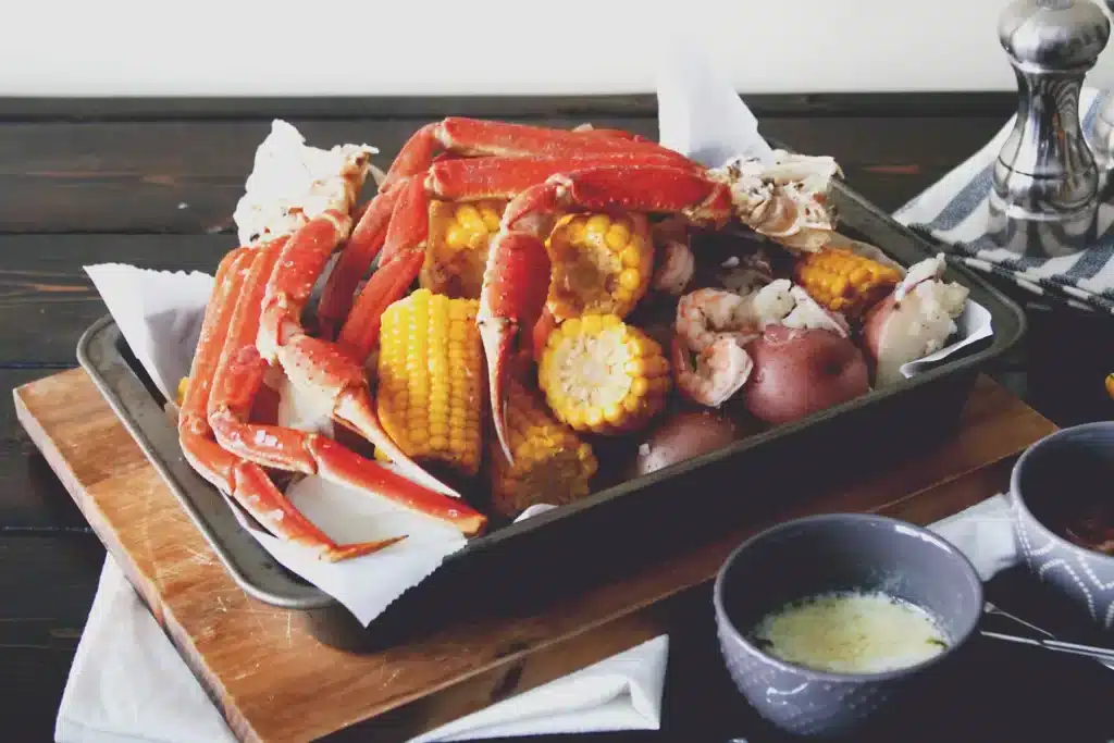 corn and crab legs with sauces