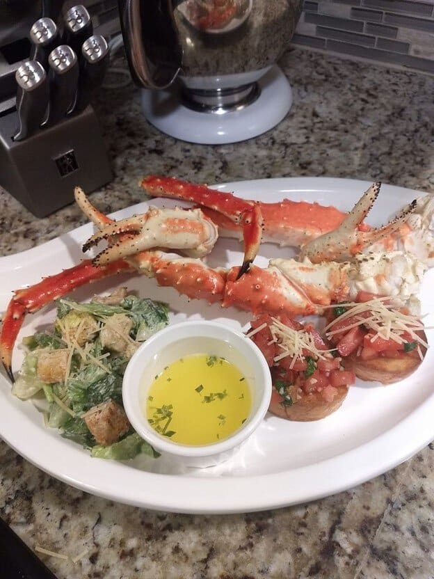 crab legs with butter sauce and ceaser salad