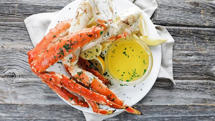 dipping sauce in a small bowl crab legs in a plate