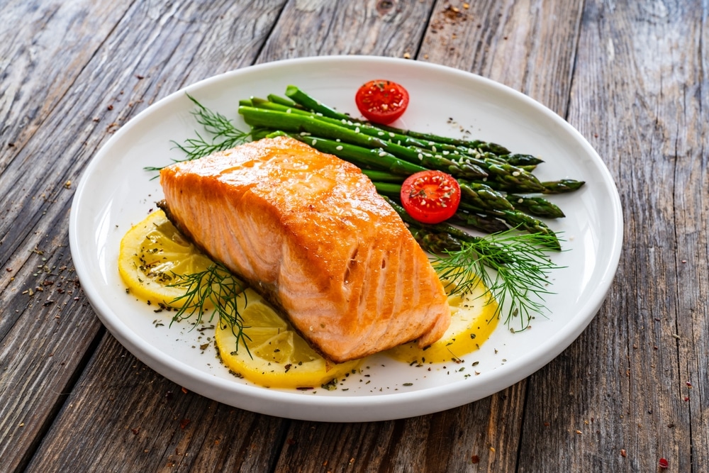 Fried Salmon Steak With Cooked Green Asparagus Cherry Tomatoes And