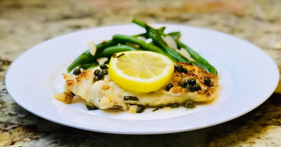 Grouper Piccata along with saute beans and lemon slice