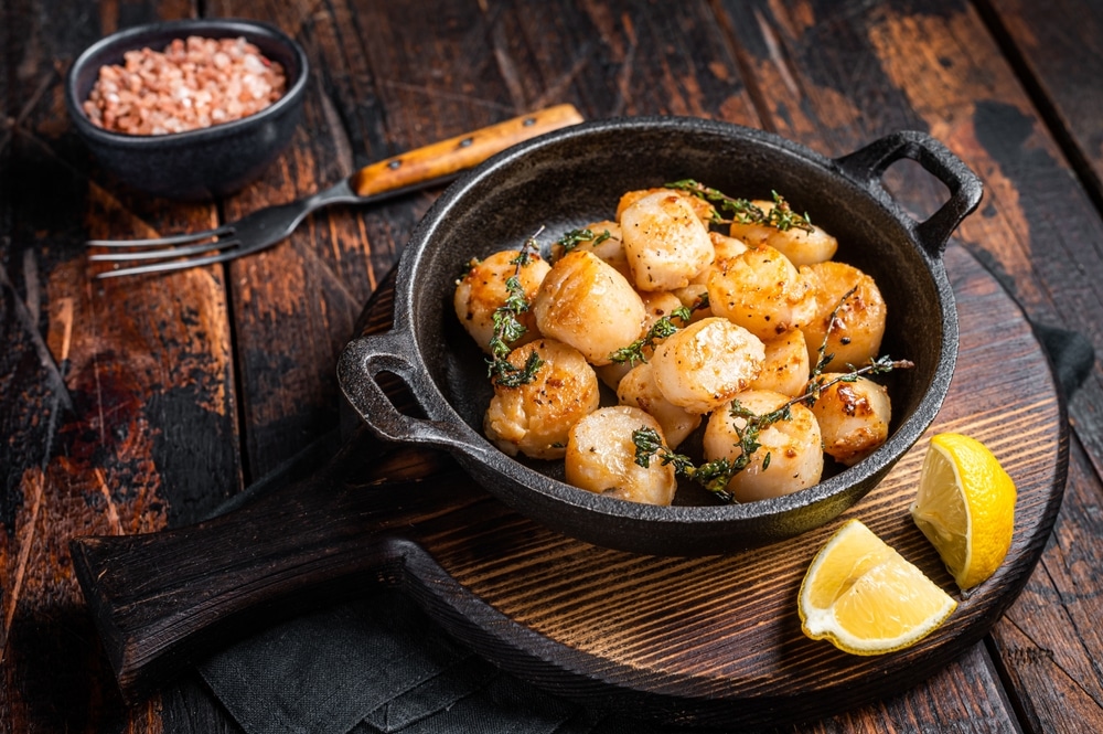 Scallops Seared In Garlic Thyme And Butter Served In Cast