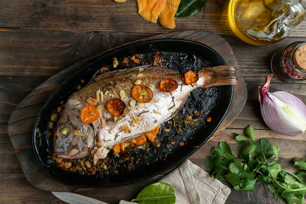 Baked Or Roasted Porgy In The Black Cast Iron Brazier