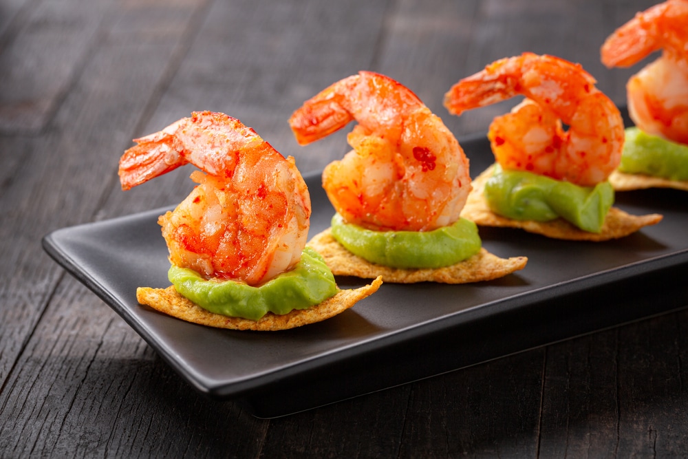 Shrimps Served On Nacho Chips With Guacamole