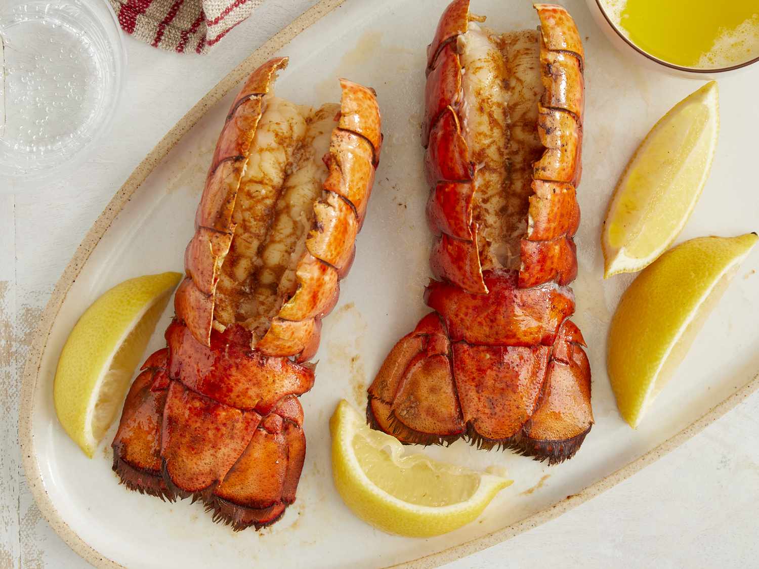 lobster tail with lemon wedges