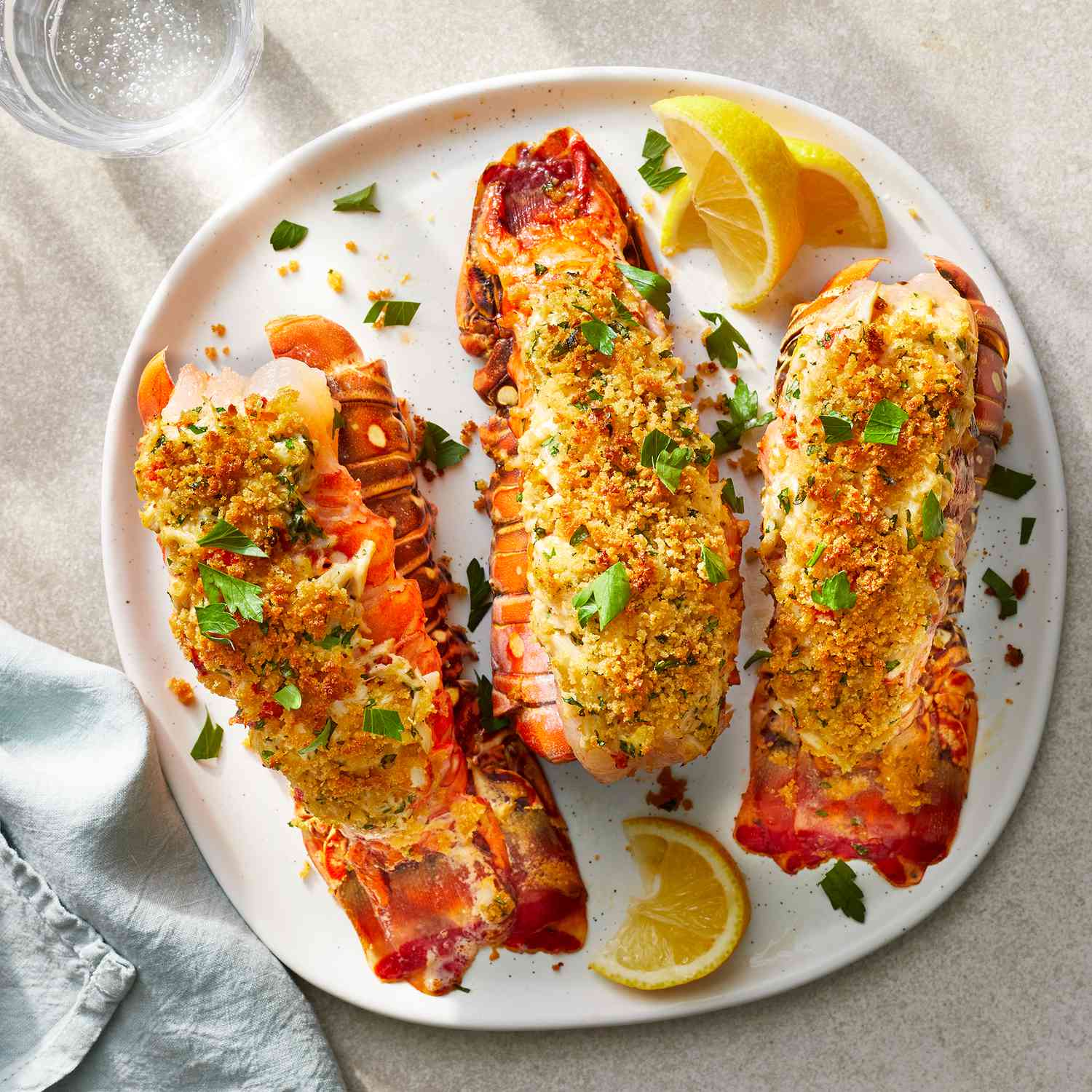 stuffed lobster tail served with lemon slices