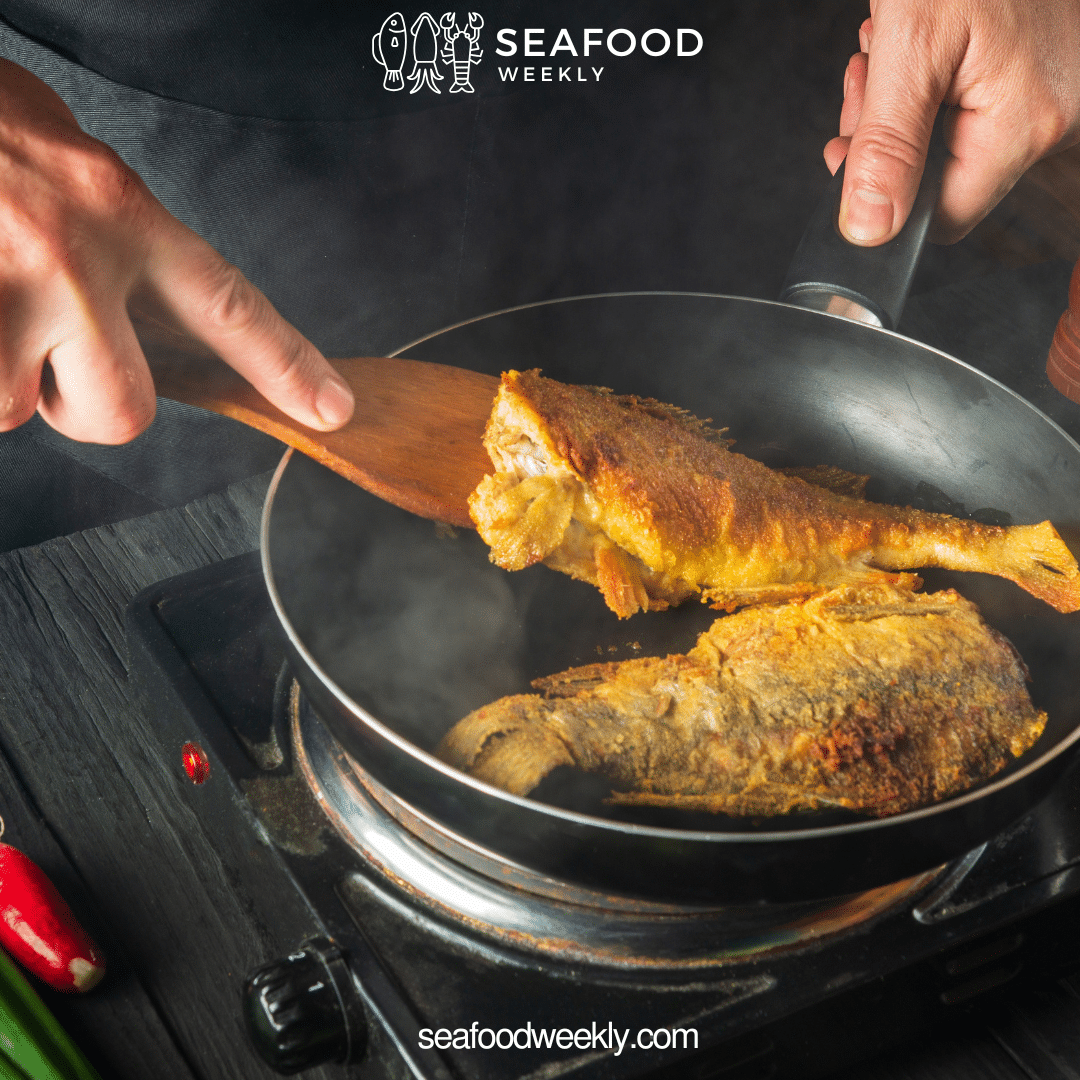 a chef cooking the porgy fish in skillet