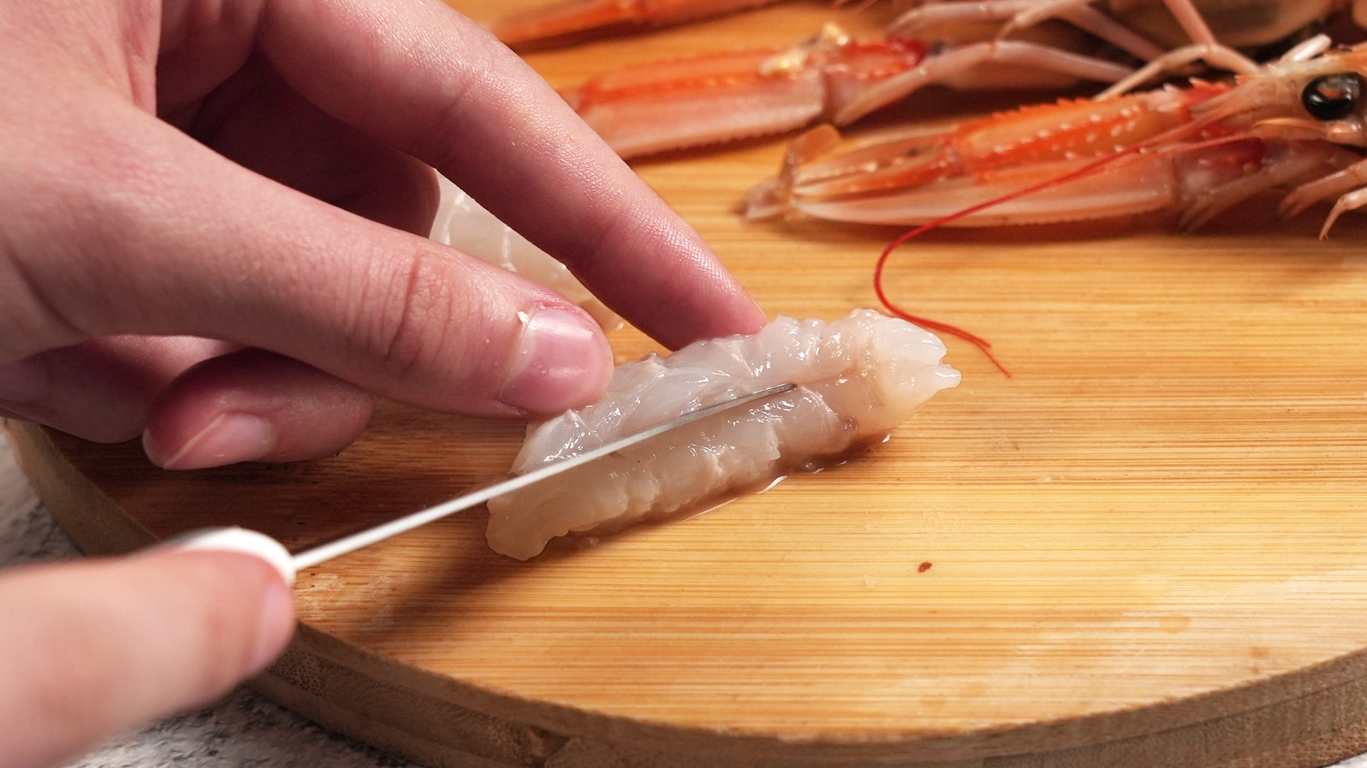 closeup of hands cutting the shrimp closeup of hands cutting the shrimp