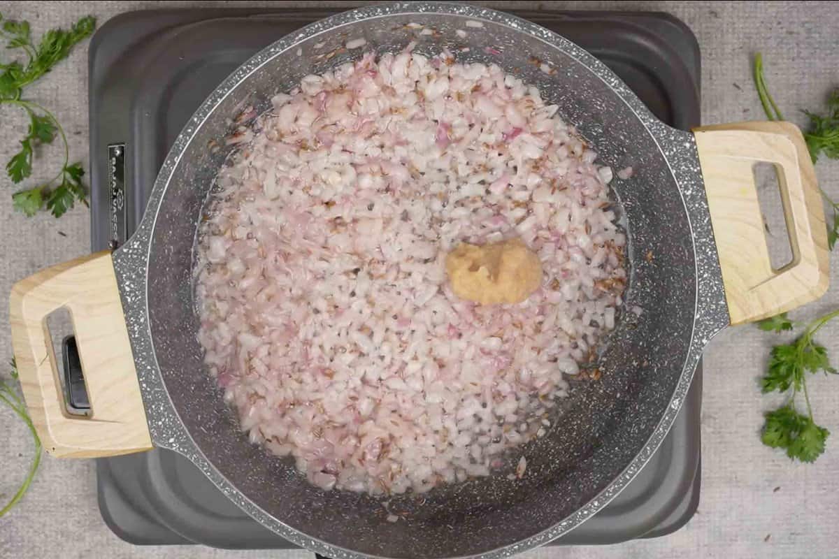 ginger garlic paste in a pan with onions ginger garlic paste in a pan with onions