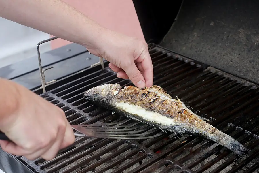 close up of 2 hands flipping fish