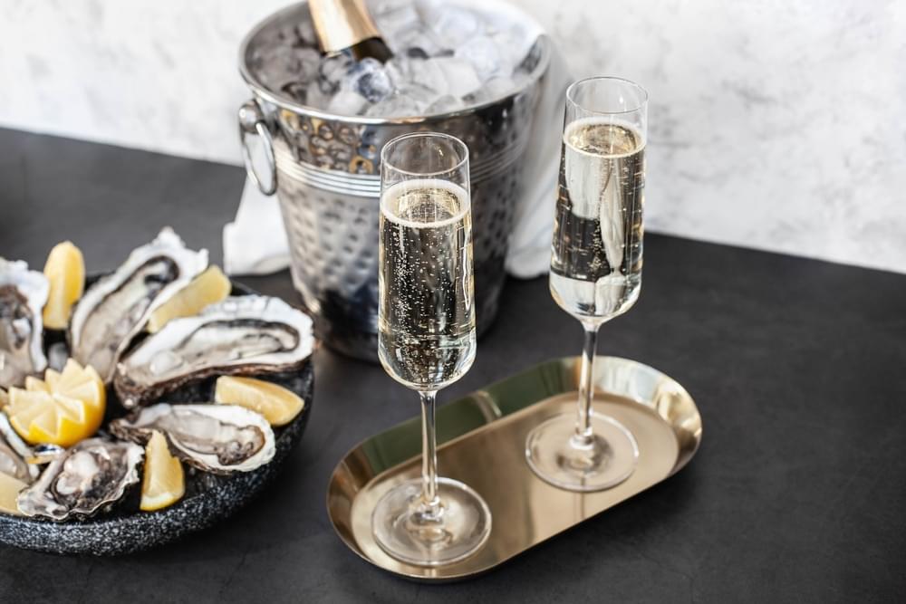 Champagne Glasses With Sparkling Wine And Bottle In Bucket Near Champagne Glasses With Sparkling Wine And Bottle In Bucket Near